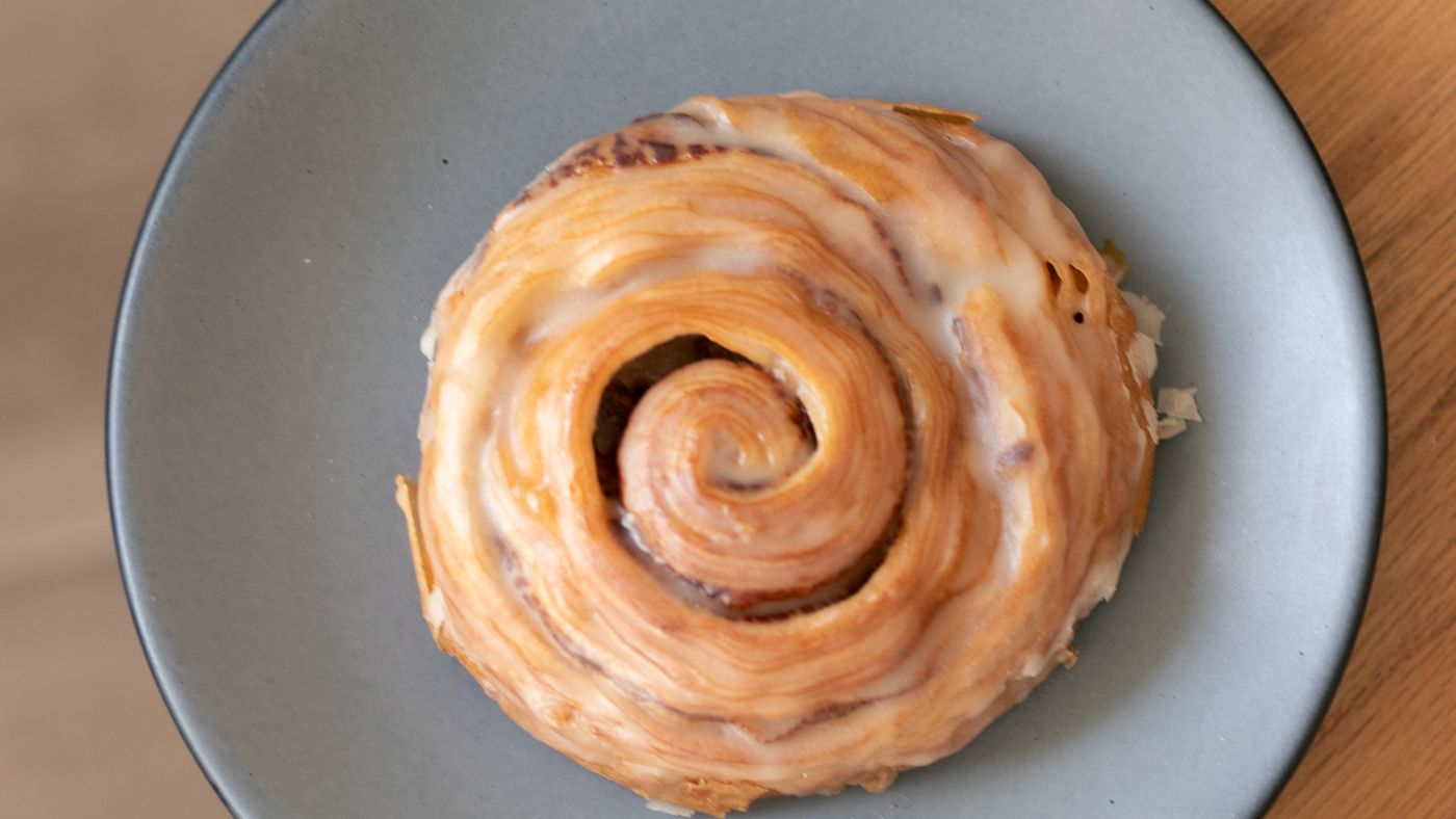 A cinnamon roll on a gray plate—the sort of evidence submitted to Food by Clef